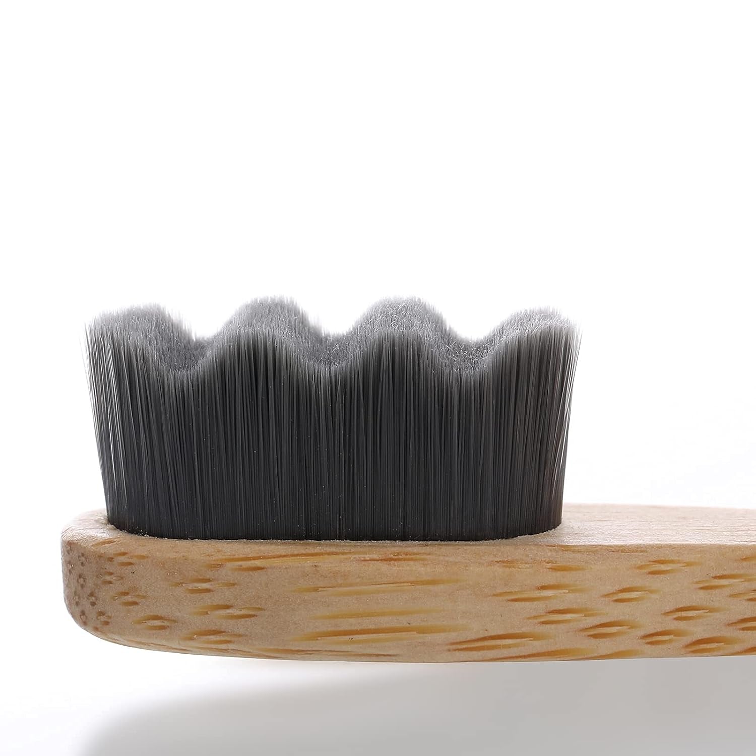 Macro detail view of Liveify natural bamboo toothbrush head showing ultra soft black wavy micro bristles