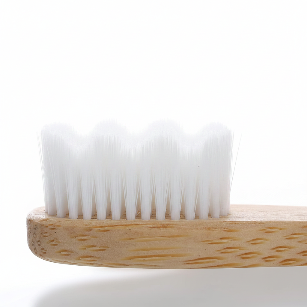 Macro detail view of Liveify natural bamboo toothbrush head showing ultra soft white wavy micro bristles