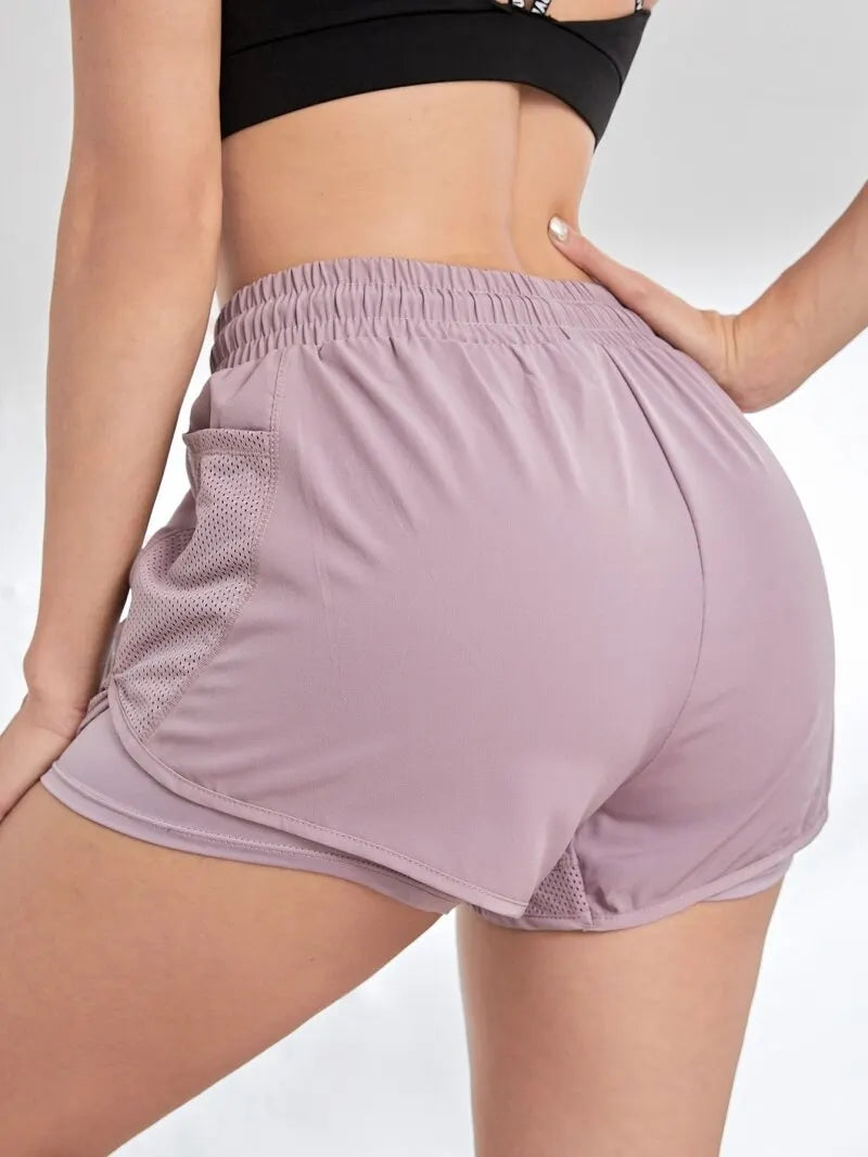 Liveify women's mauve athletic shorts with mesh side pockets and elastic waistband, ideal for gym or running
