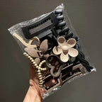 Liveify assorted hair clips in black, beige, and brown with floral, beaded, and geometric designs in clear packaging