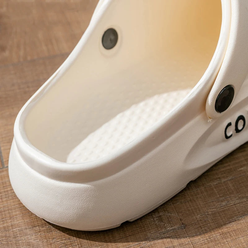 Liveify white clog sandal with textured footbed and ventilation holes on wooden floor