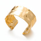 Liveify gold hammered cuff bracelet with textured finish on soft fabric background