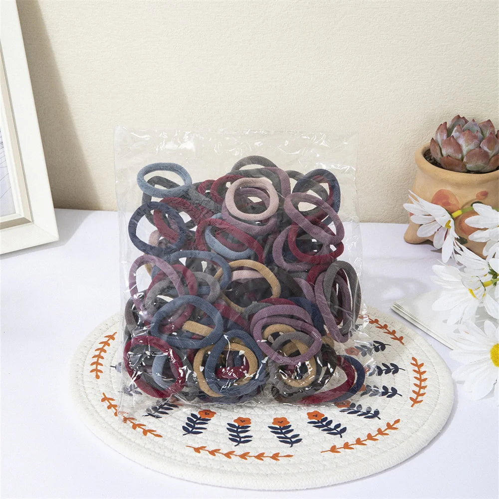 Liveify assorted velvet hair ties in clear bag, soft elastic bands for ponytails, multi-color set on floral mat