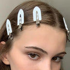 Liveify white hair clips with metallic clasp, stylishly holding hair back for a clean look