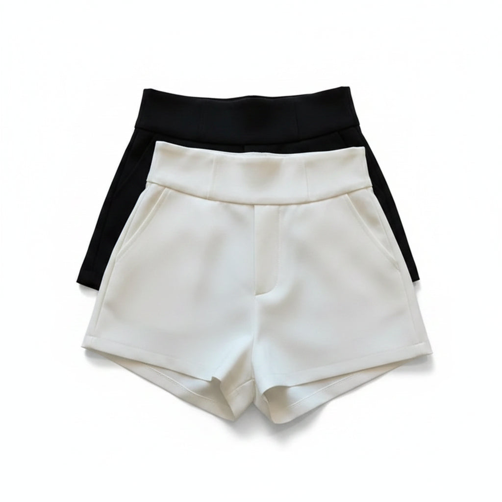 Liveify white and black high-waisted shorts with belt detail, stylish women's fashion on beige couch