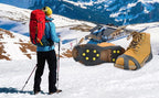 Liveify tan hiking boots with gray crampon-style traction cleats on snowy mountain trail, ideal for winter trekking