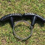 Liveify black plastic handles with textured grip and metal wire loop on grass