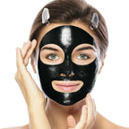 Liveify black charcoal face mask with eye and mouth cutouts, glossy texture, woman applying with hands