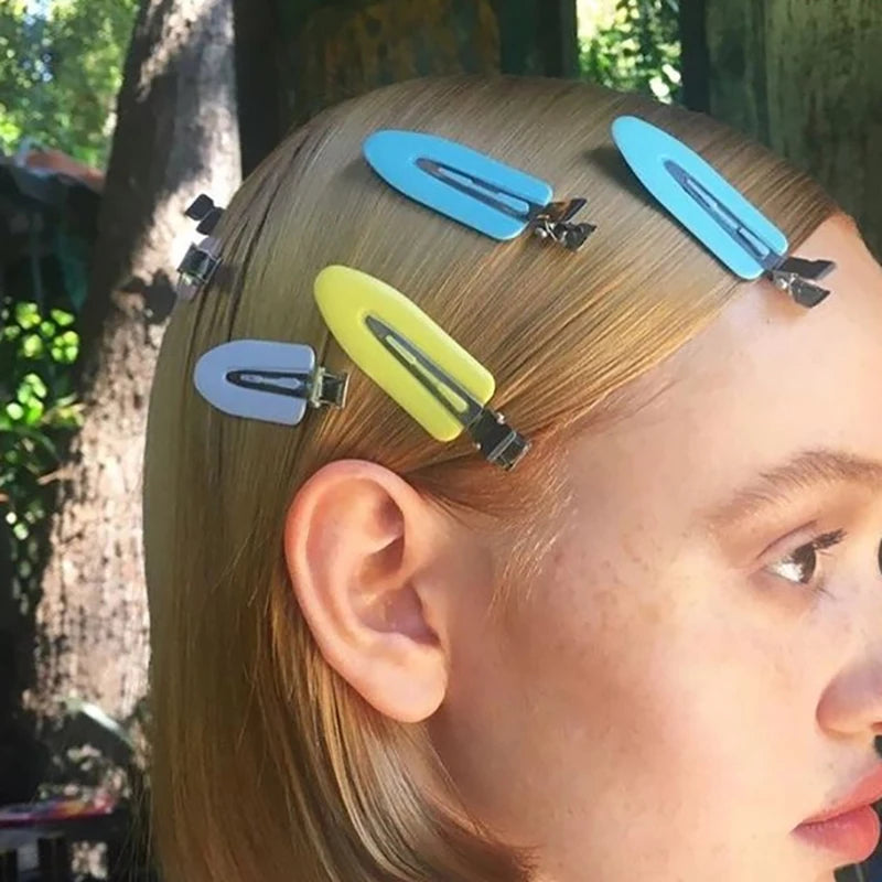 Liveify pastel hair clips in blue, yellow, and gray holding blonde hair, stylish accessory for everyday looks