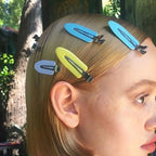 Liveify pastel hair clips in blue, yellow, and gray holding blonde hair, stylish accessory for everyday looks