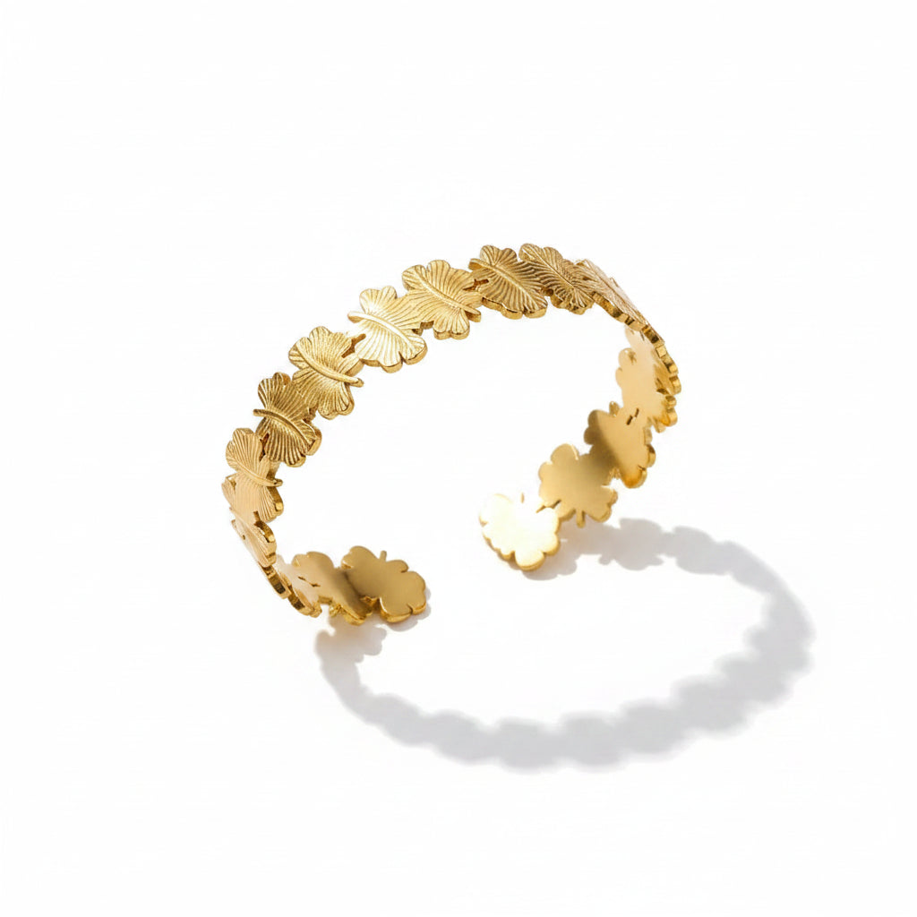 Liveify gold leaf cuff bracelet with textured botanical design on soft fabric background
