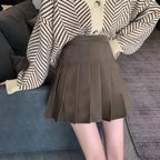 Liveify brown pleated mini skirt with high waist, paired with striped knit cardigan, casual women's fashion
