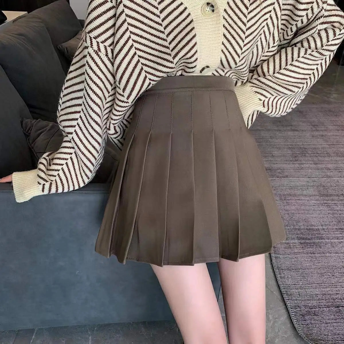 Liveify brown pleated mini skirt with high waist, paired with striped knit cardigan, casual women's fashion