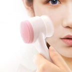 Liveify pink silicone facial cleansing brush with white handle, used for skincare routine