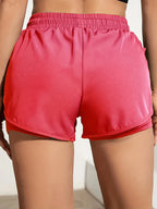 Liveify pink athletic shorts with elastic waistband and side pockets, lightweight fabric for workout or casual wear
