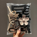 Liveify assorted hair claw clips in black, beige, and brown with flower, butterfly, and beaded designs in clear packaging