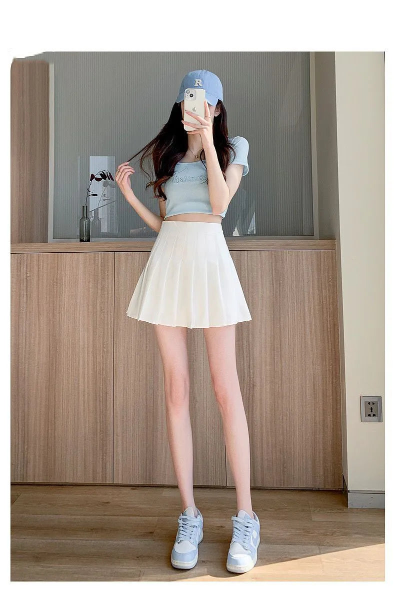 Liveify white pleated tennis skirt with light blue crop top and matching sneakers, casual summer outfit