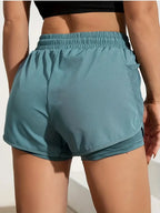 Liveify teal athletic shorts with mesh side pocket and elastic waistband