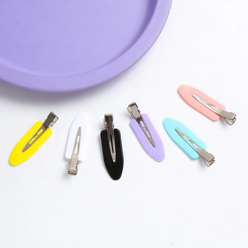 Liveify pastel and bold colored hair clips with metal clasp, matte finish, arranged on white surface near purple plate