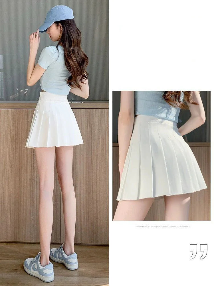 Liveify white pleated tennis skirt with side pockets, worn with light blue crop top and sneakers