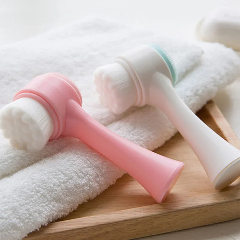 Liveify pink and white silicone facial cleansing brushes with soft bristles on towel