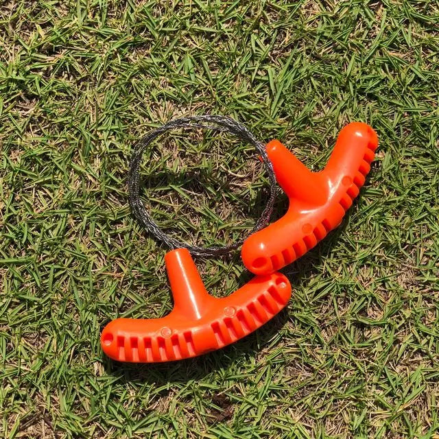 Liveify orange plastic pet waste picker with textured grip and metal cable on grass