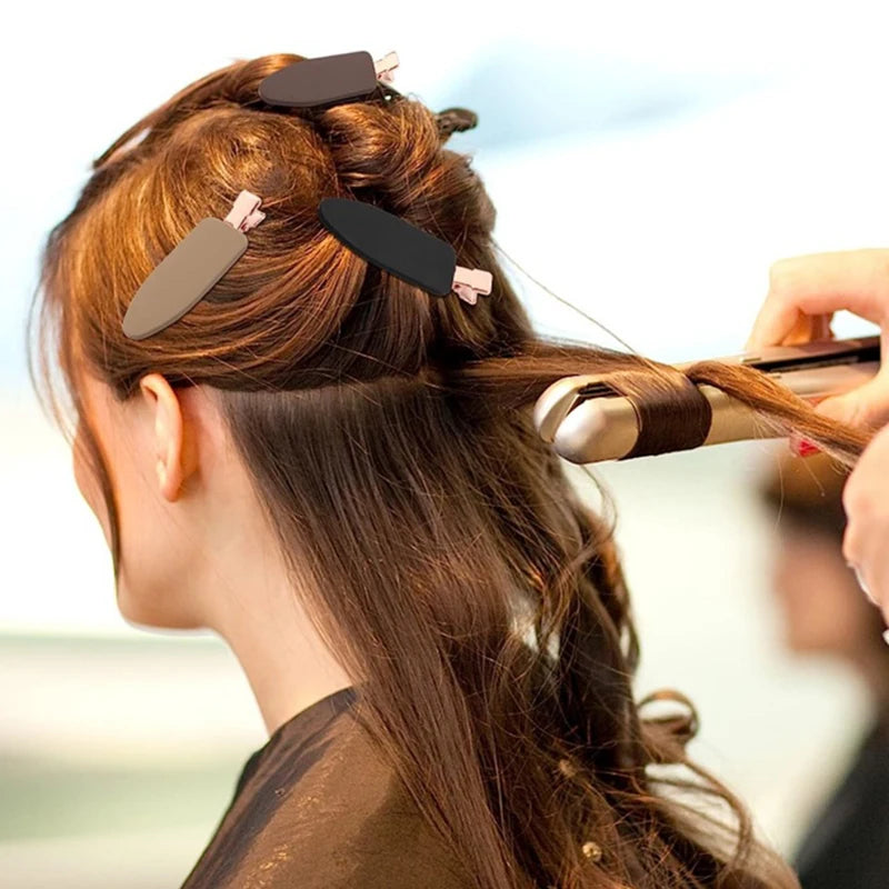 Liveify black and beige hair clips holding sections of brown hair during styling with a curling iron