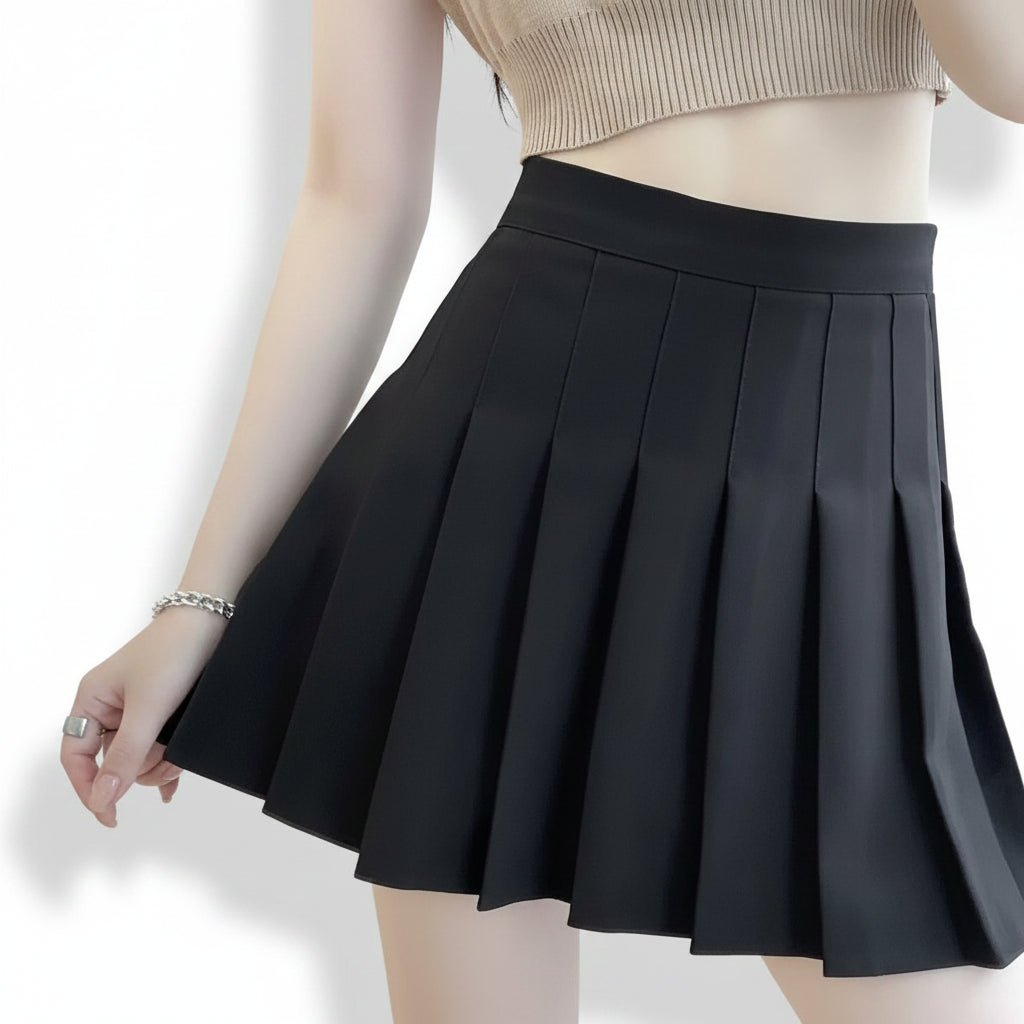 Liveify black pleated mini skirt with high waist, worn with ribbed crop top, stylish women's fashion