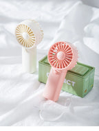 Liveify portable handheld fan in pink and cream, USB rechargeable mini fan with carry strap, soft plastic design