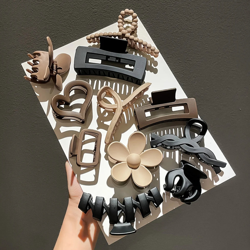 Liveify assorted hair clips in black, beige, and brown with heart, flower, and twisted designs on white tray