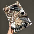 Liveify assorted hair clips in black, beige, and brown with heart, flower, and twisted designs on white tray