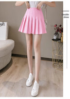 Liveify pink pleated mini skirt with high waist, paired with white sneakers, casual summer style