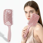 Liveify pink detangling hair brush with soft bristles, held by woman, ideal for beauty and looksmaxing routines